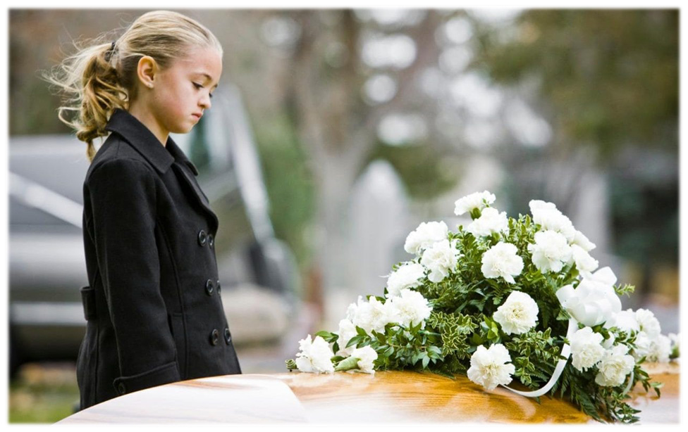 Young child looking at a casket