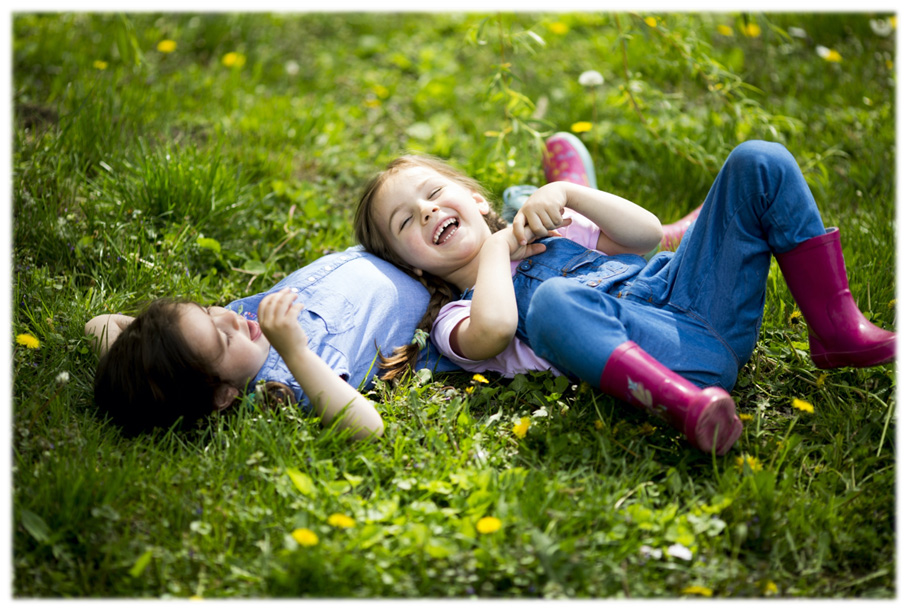 Two children playing in the grass